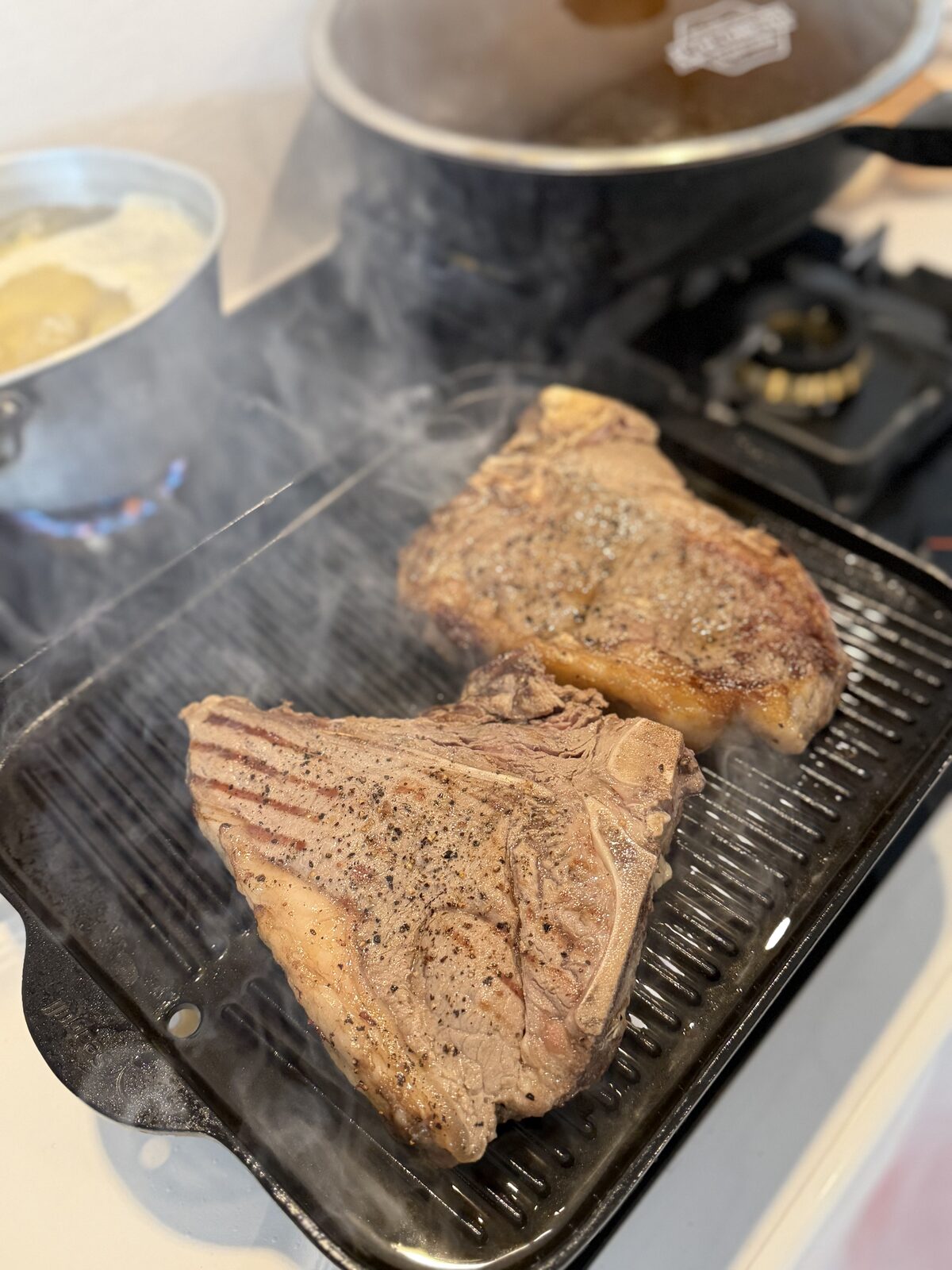 Steaks grilling, prepared by Ben Cunningham